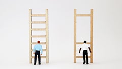 white man standing in front of ladder with 7 evenly spaced rungs next to black man in front of equally tall ladder, but only 3 rungs with larger spaces between