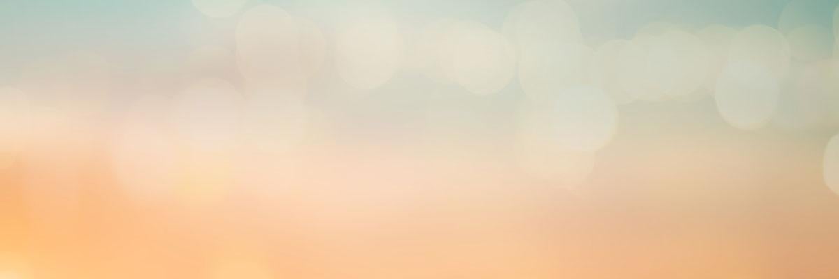A background image with a gradient of blue at the top and peach at the bottom.