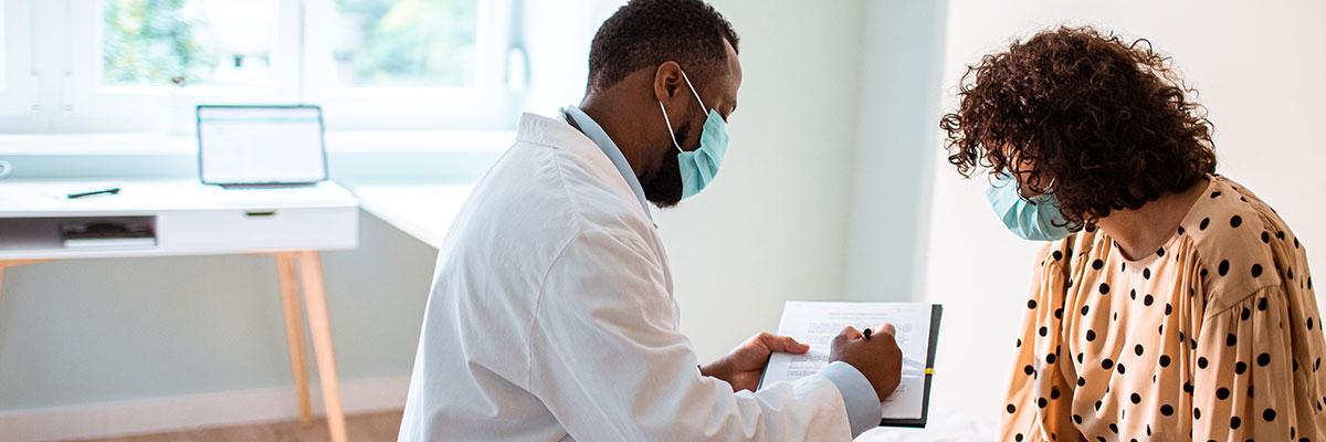 A Black physician shares test results with a patient of color.